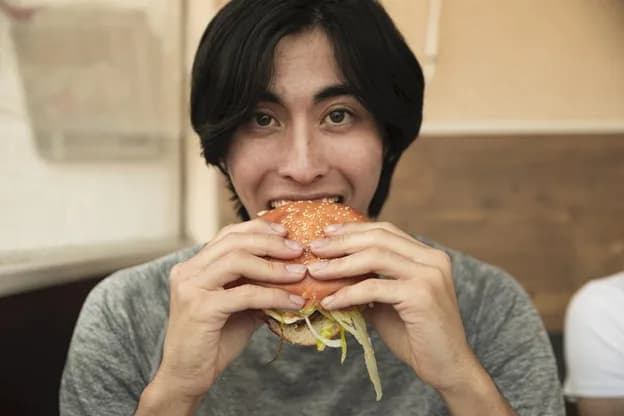 A balanced plate with smaller portions of indulgent food paired with a generous serving of fresh salad