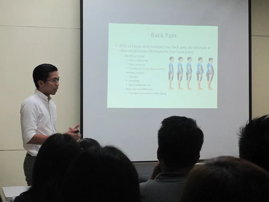 Dr. Jan Michael Lleva speaking at the SPCMC Industrial Clinic Division's lecture on work-related pain.