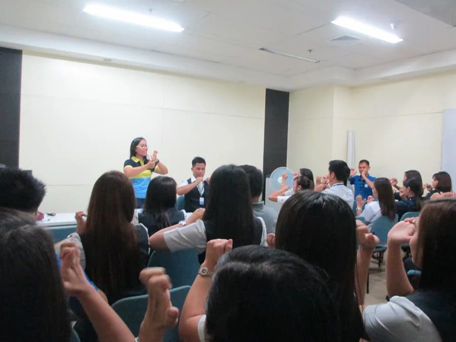 Participants engaging in physical exercises demonstrated by a physical therapist.